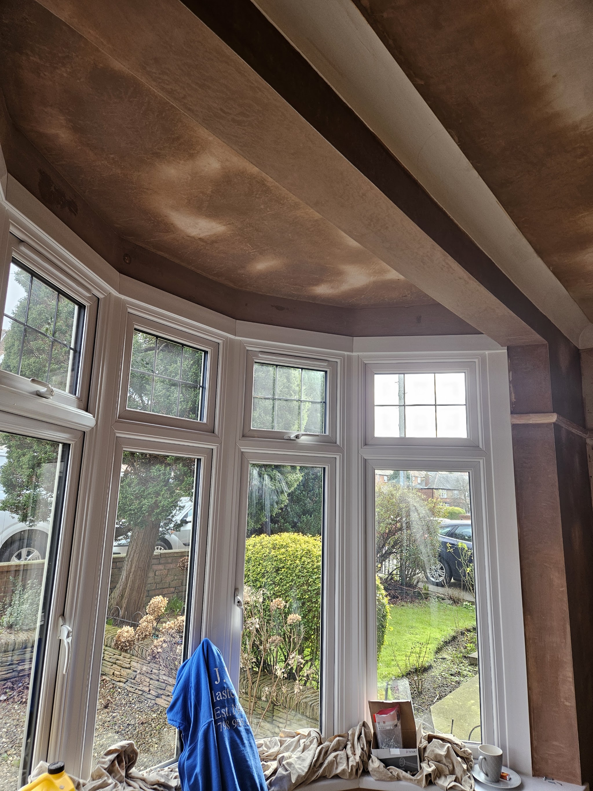 A room plastered ready for decorating, with spotlights in the ceiling